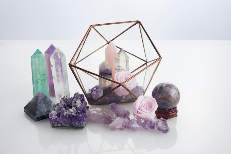 A selection of tumbled crystals and chakra wands.